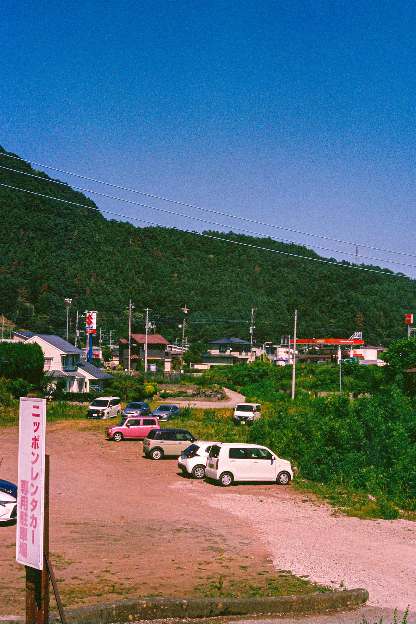 A hillside town beneath a deep blue sky