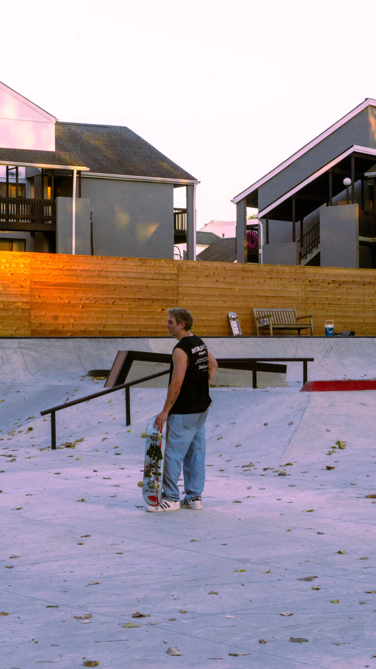 A skateboarder at a pastel-colored skatepark